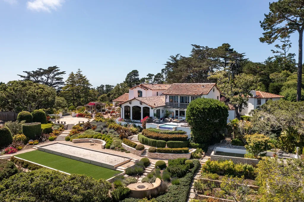 1463 Oleada Road Home in Pebble Beach, California. Explore the timeless elegance of Bella Vista, an original Pebble Beach estate nestled atop Strawberry Hill. This gated 2.6-acre haven offers panoramic views, lush gardens, and modern amenities. With a renovated 8,500+ sq ft main house, a guest house, and a studio carriage house, this Spanish-style compound showcases extraordinary entertaining spaces, outdoor fireplaces, a sport court, and more. Indulge in gourmet living with a chef's kitchen, wine cellar, and billiards room. 