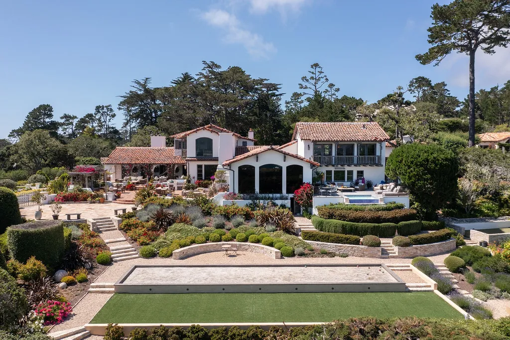 1463 Oleada Road Home in Pebble Beach, California. Explore the timeless elegance of Bella Vista, an original Pebble Beach estate nestled atop Strawberry Hill. This gated 2.6-acre haven offers panoramic views, lush gardens, and modern amenities. With a renovated 8,500+ sq ft main house, a guest house, and a studio carriage house, this Spanish-style compound showcases extraordinary entertaining spaces, outdoor fireplaces, a sport court, and more. Indulge in gourmet living with a chef's kitchen, wine cellar, and billiards room. 