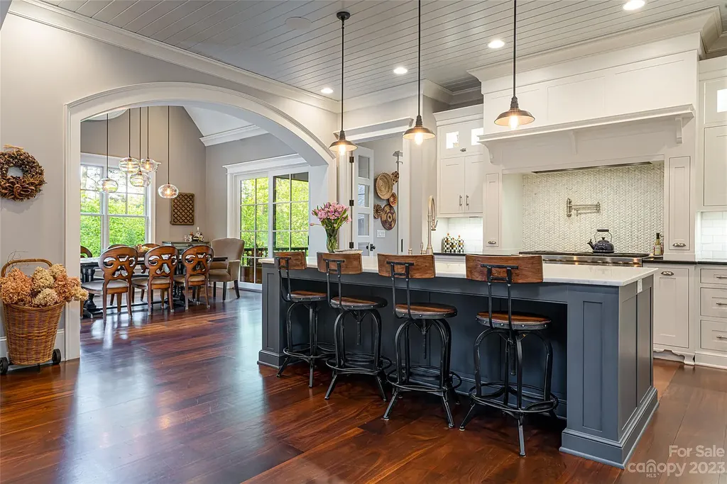 15 Presque Isle Way Home in Asheville, North Carolina. Discover the epitome of sophistication and elegance in this custom home situated on a quiet cul-de-sac. With high-quality finishes throughout, the open floor plan seamlessly integrates indoor and outdoor living spaces, including a chef's kitchen, great room, dining area, and a main level primary suite. 