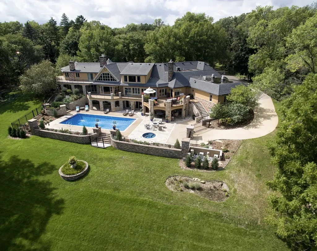 16 Evergreen Road Home in North Oaks, Minnesota. Experience luxury living at its finest in this exceptional estate nestled within the esteemed North Oaks Community, situated on the original James J. Hill Homestead. This remarkable property offers a plethora of outstanding features, including an awe-inspiring pool area adorned with fountains, lights, hidden waterproof speakers, a jacuzzi, and even an indoor sauna.