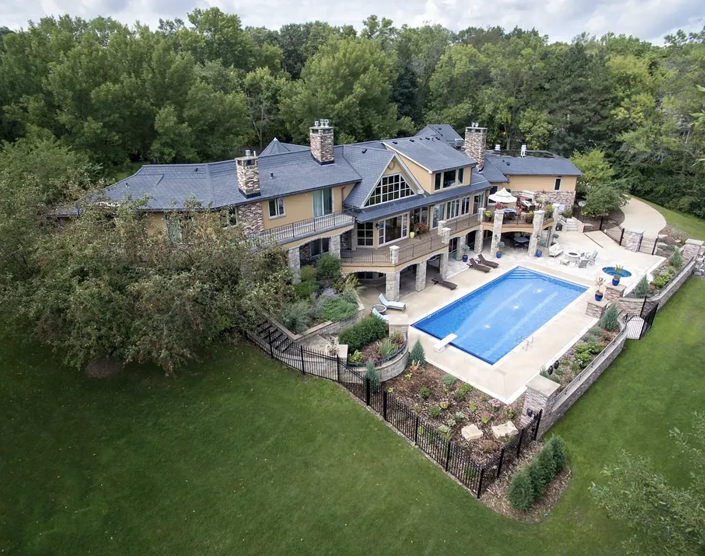 16 Evergreen Road Home in North Oaks, Minnesota. Experience luxury living at its finest in this exceptional estate nestled within the esteemed North Oaks Community, situated on the original James J. Hill Homestead. This remarkable property offers a plethora of outstanding features, including an awe-inspiring pool area adorned with fountains, lights, hidden waterproof speakers, a jacuzzi, and even an indoor sauna.