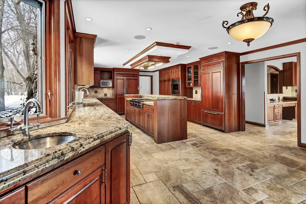 16 Evergreen Road Home in North Oaks, Minnesota. Experience luxury living at its finest in this exceptional estate nestled within the esteemed North Oaks Community, situated on the original James J. Hill Homestead. This remarkable property offers a plethora of outstanding features, including an awe-inspiring pool area adorned with fountains, lights, hidden waterproof speakers, a jacuzzi, and even an indoor sauna.