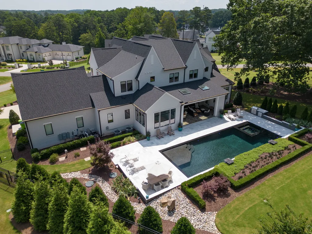 1632 Estate Valley Lane Home in Raleigh, North Carolina. Step into a realm where the pressures of daily life dissolve into the serene blue depths of the pool. Experience daily pampering while engaging in ordinary activities. This impeccable residence seamlessly blends the finest aspects of living, incorporating design and upgrades that effortlessly enhance ease and comfort. 