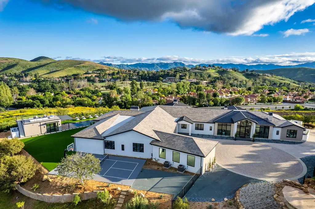 1856 Dawn Meadow Street Home in Thousand Oaks, California. Discover the pinnacle of luxury living in this newly constructed contemporary masterpiece nestled in North Ranch's High Country section. With 11,000 square feet of single-story opulence, this 6-bedroom, 9-bathroom home features a theater, wine wall, game room, and more. 