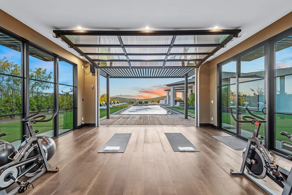 1856 Dawn Meadow Street Home in Thousand Oaks, California. Discover the pinnacle of luxury living in this newly constructed contemporary masterpiece nestled in North Ranch's High Country section. With 11,000 square feet of single-story opulence, this 6-bedroom, 9-bathroom home features a theater, wine wall, game room, and more. 