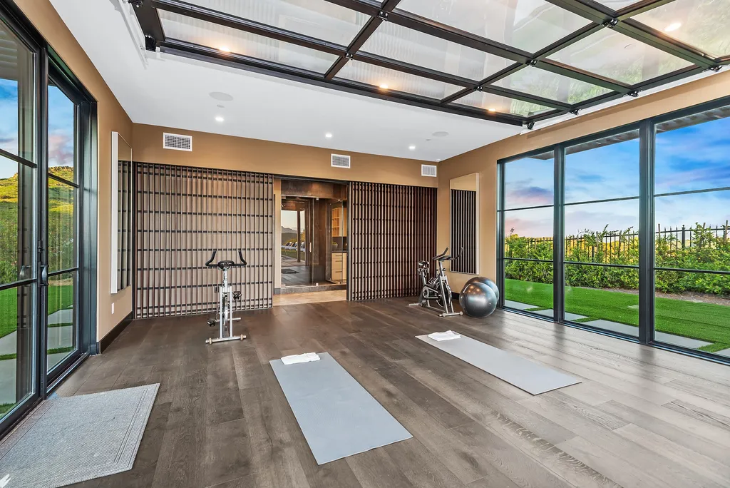 1856 Dawn Meadow Street Home in Thousand Oaks, California. Discover the pinnacle of luxury living in this newly constructed contemporary masterpiece nestled in North Ranch's High Country section. With 11,000 square feet of single-story opulence, this 6-bedroom, 9-bathroom home features a theater, wine wall, game room, and more. 