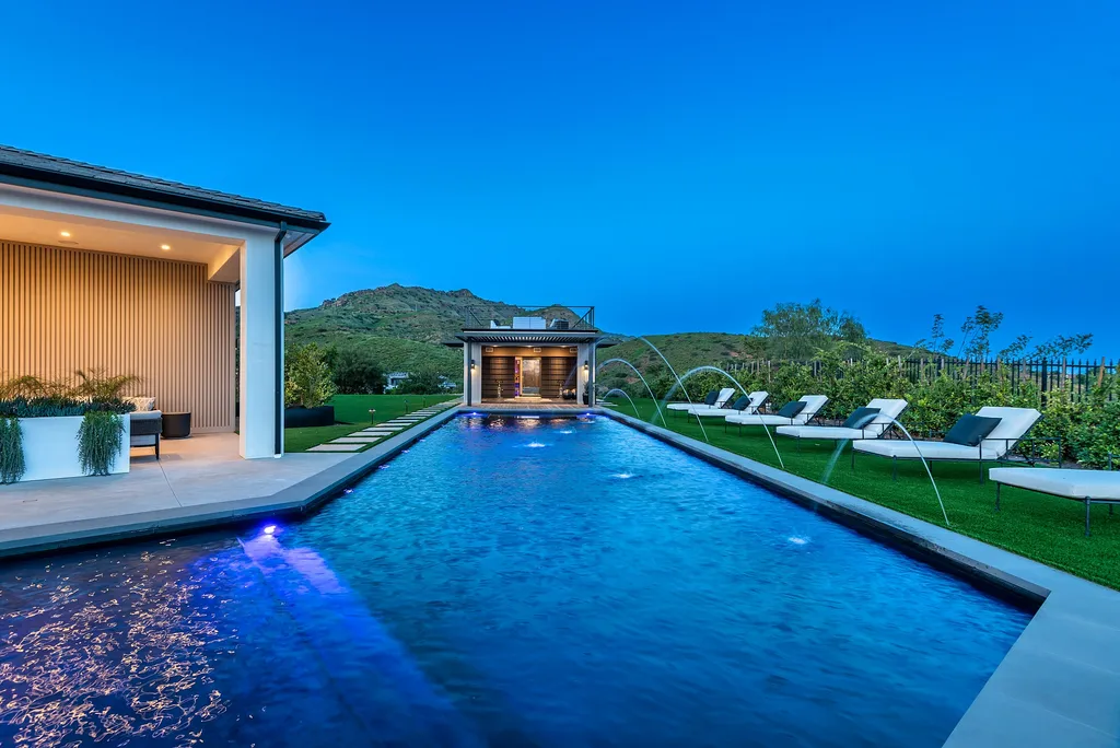 1856 Dawn Meadow Street Home in Thousand Oaks, California. Discover the pinnacle of luxury living in this newly constructed contemporary masterpiece nestled in North Ranch's High Country section. With 11,000 square feet of single-story opulence, this 6-bedroom, 9-bathroom home features a theater, wine wall, game room, and more. 