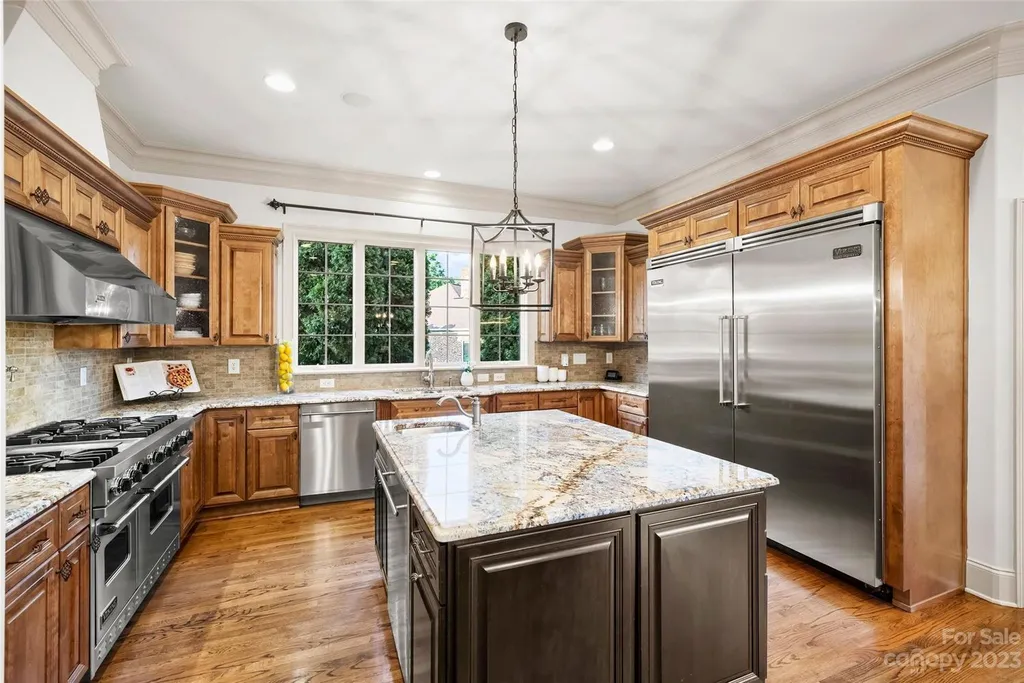 18726 John Connor Road Home in Cornelius, North Carolina. Discover a French-Tudor masterpiece where classic elegance harmoniously merges with contemporary comfort. This estate presents an enchanting façade with steep roofs, tall windows, and intricate wrought iron accents that embody ageless allure.