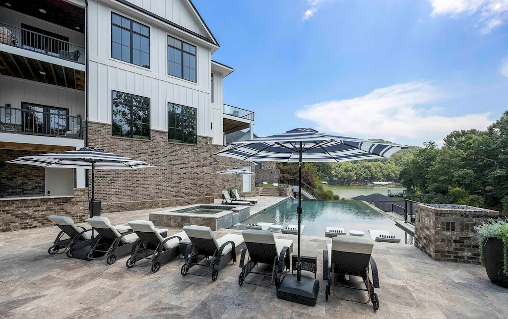2050 Hidden Cove Lane Home in Knoxville, Tennessee. Welcome to your lakefront dream nestled in the coveted Choto area of West Knoxville! Tucked away at the end of a private road, this exceptional residence graces a tranquil cove, offering both seclusion and awe-inspiring water views. Recently constructed in 2021, this opulent estate seamlessly marries timeless elegance with contemporary refinement.