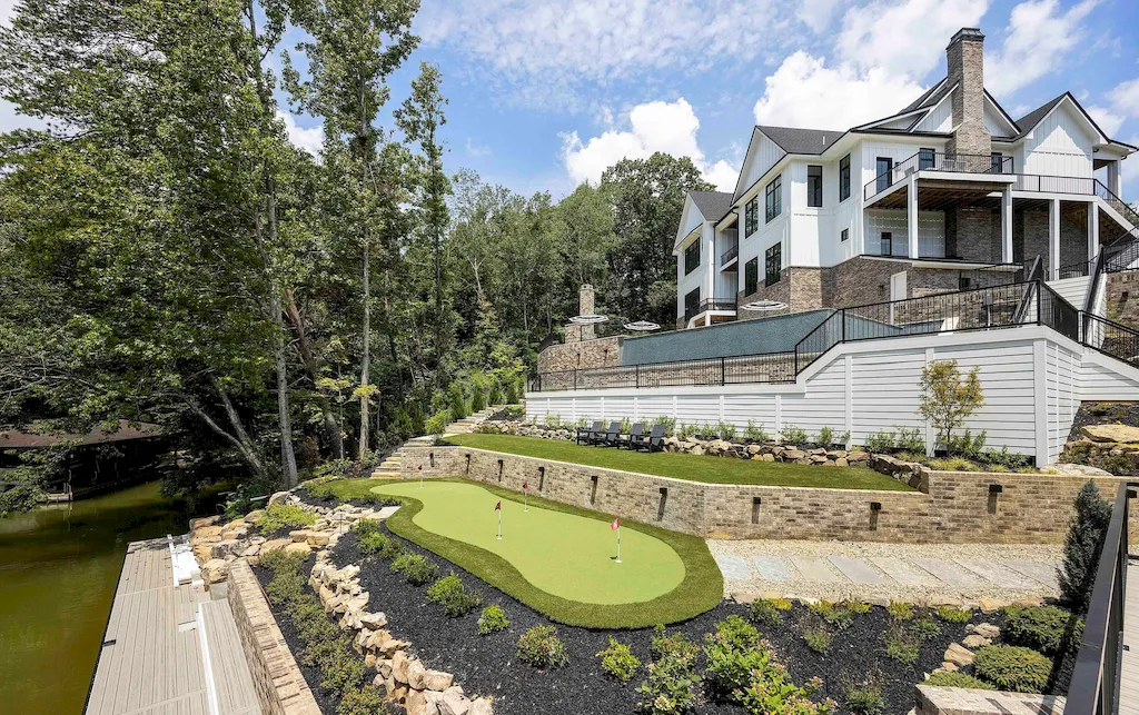 2050 Hidden Cove Lane Home in Knoxville, Tennessee. Welcome to your lakefront dream nestled in the coveted Choto area of West Knoxville! Tucked away at the end of a private road, this exceptional residence graces a tranquil cove, offering both seclusion and awe-inspiring water views. Recently constructed in 2021, this opulent estate seamlessly marries timeless elegance with contemporary refinement.