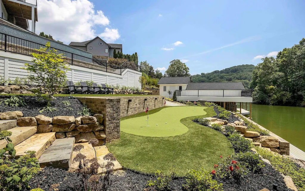 2050 Hidden Cove Lane Home in Knoxville, Tennessee. Welcome to your lakefront dream nestled in the coveted Choto area of West Knoxville! Tucked away at the end of a private road, this exceptional residence graces a tranquil cove, offering both seclusion and awe-inspiring water views. Recently constructed in 2021, this opulent estate seamlessly marries timeless elegance with contemporary refinement.