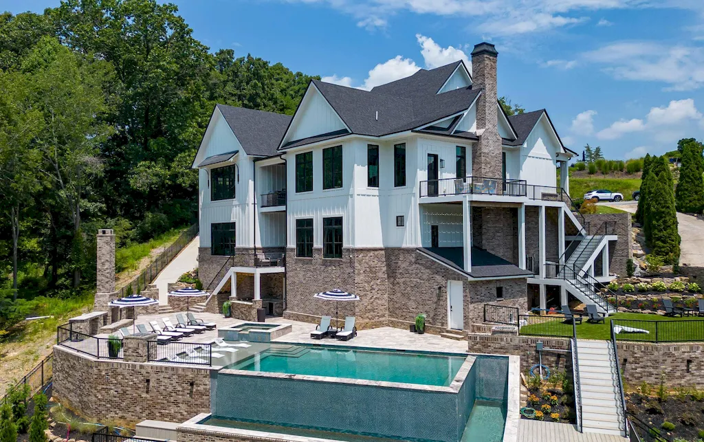 2050 Hidden Cove Lane Home in Knoxville, Tennessee. Welcome to your lakefront dream nestled in the coveted Choto area of West Knoxville! Tucked away at the end of a private road, this exceptional residence graces a tranquil cove, offering both seclusion and awe-inspiring water views. Recently constructed in 2021, this opulent estate seamlessly marries timeless elegance with contemporary refinement.