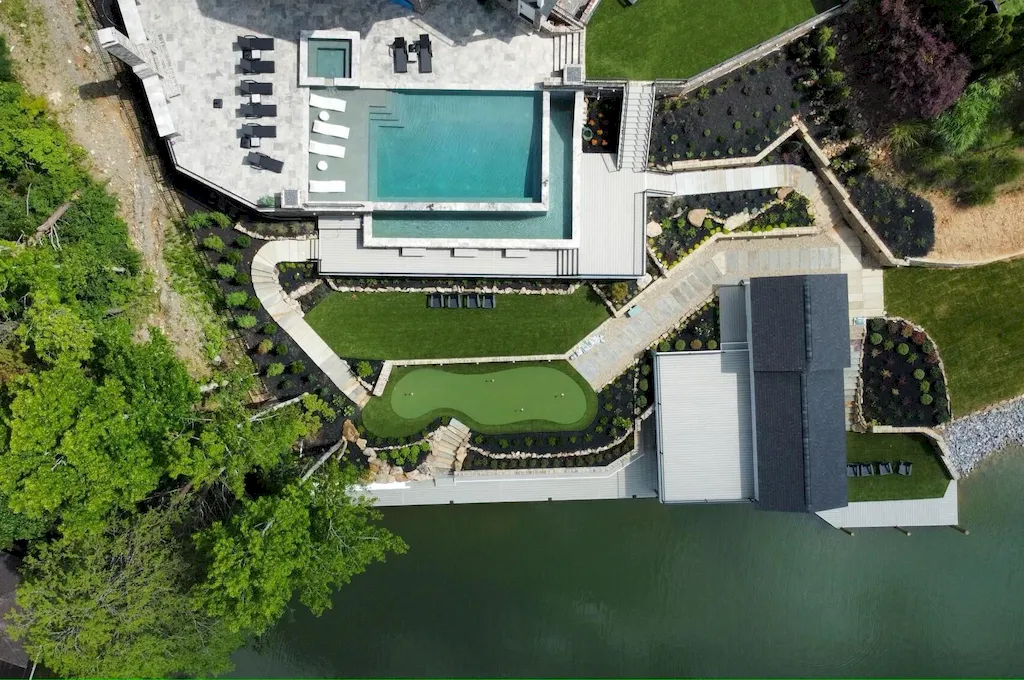 2050 Hidden Cove Lane Home in Knoxville, Tennessee. Welcome to your lakefront dream nestled in the coveted Choto area of West Knoxville! Tucked away at the end of a private road, this exceptional residence graces a tranquil cove, offering both seclusion and awe-inspiring water views. Recently constructed in 2021, this opulent estate seamlessly marries timeless elegance with contemporary refinement.
