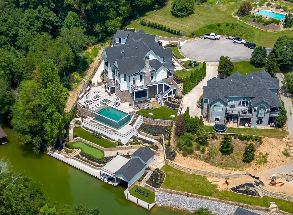 2050 Hidden Cove Lane Home in Knoxville, Tennessee. Welcome to your lakefront dream nestled in the coveted Choto area of West Knoxville! Tucked away at the end of a private road, this exceptional residence graces a tranquil cove, offering both seclusion and awe-inspiring water views. Recently constructed in 2021, this opulent estate seamlessly marries timeless elegance with contemporary refinement.