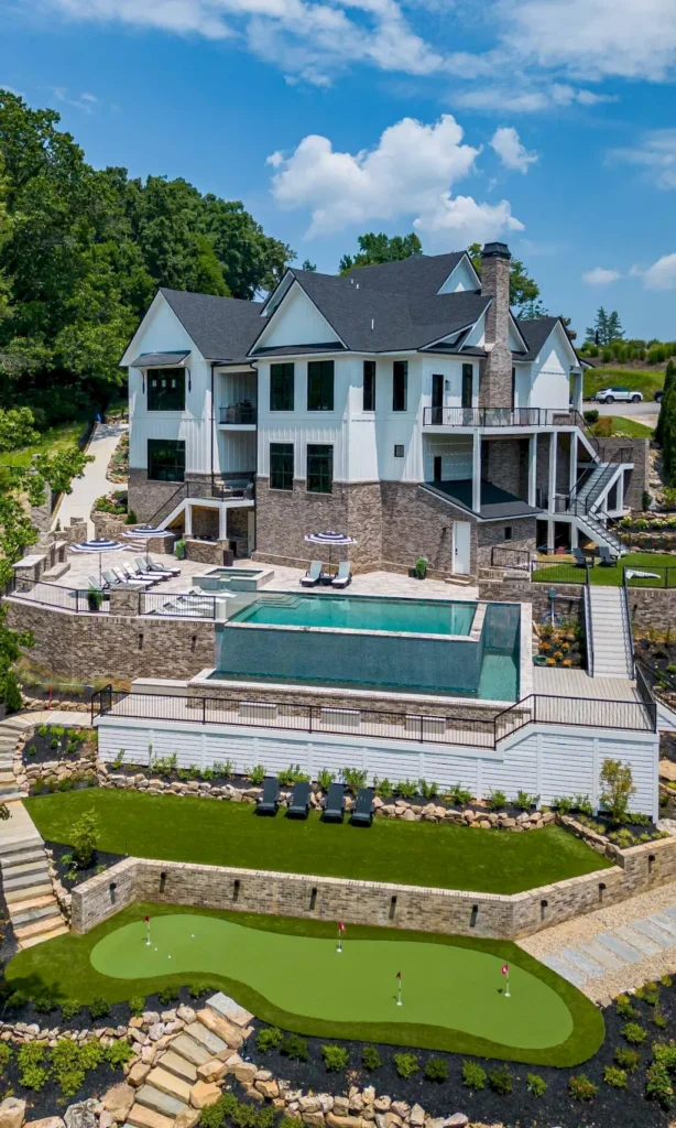 2050 Hidden Cove Lane Home in Knoxville, Tennessee. Welcome to your lakefront dream nestled in the coveted Choto area of West Knoxville! Tucked away at the end of a private road, this exceptional residence graces a tranquil cove, offering both seclusion and awe-inspiring water views. Recently constructed in 2021, this opulent estate seamlessly marries timeless elegance with contemporary refinement.