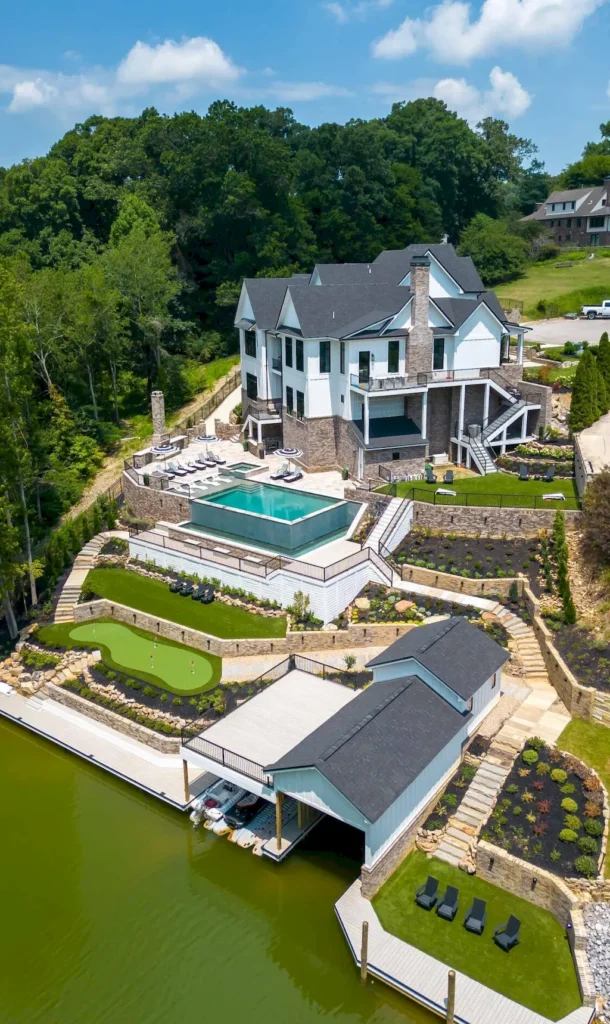 2050 Hidden Cove Lane Home in Knoxville, Tennessee. Welcome to your lakefront dream nestled in the coveted Choto area of West Knoxville! Tucked away at the end of a private road, this exceptional residence graces a tranquil cove, offering both seclusion and awe-inspiring water views. Recently constructed in 2021, this opulent estate seamlessly marries timeless elegance with contemporary refinement.