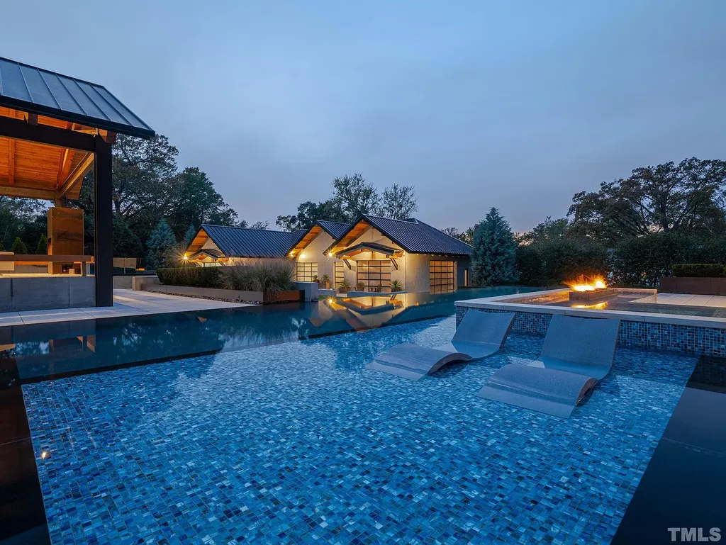 2315 Beechridge Road Home in Raleigh, North Carolina. Step into a modernist masterpiece where open living, natural light, and dramatic vaulted ceilings converge. This architectural gem is a true work of art, featuring a harmonious blend of unique natural woods, contemporary materials, and expansive windows. Discover a sanctuary of tranquility and design, nestled on an acre plus lot in Raleigh's sought-after legacy neighborhood.