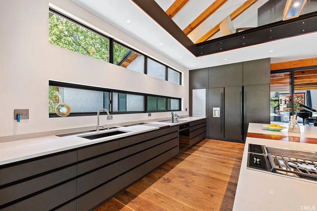 2315 Beechridge Road Home in Raleigh, North Carolina. Step into a modernist masterpiece where open living, natural light, and dramatic vaulted ceilings converge. This architectural gem is a true work of art, featuring a harmonious blend of unique natural woods, contemporary materials, and expansive windows. Discover a sanctuary of tranquility and design, nestled on an acre plus lot in Raleigh's sought-after legacy neighborhood.