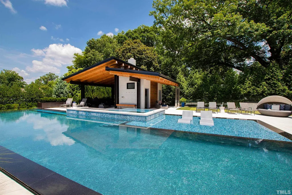 2315 Beechridge Road Home in Raleigh, North Carolina. Step into a modernist masterpiece where open living, natural light, and dramatic vaulted ceilings converge. This architectural gem is a true work of art, featuring a harmonious blend of unique natural woods, contemporary materials, and expansive windows. Discover a sanctuary of tranquility and design, nestled on an acre plus lot in Raleigh's sought-after legacy neighborhood.