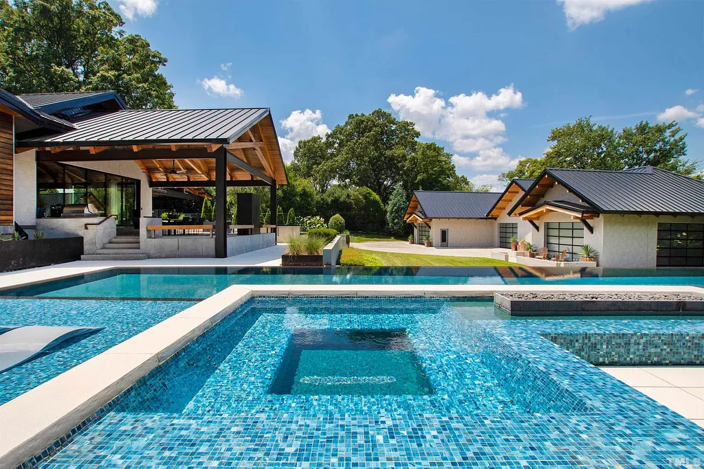 2315 Beechridge Road Home in Raleigh, North Carolina. Step into a modernist masterpiece where open living, natural light, and dramatic vaulted ceilings converge. This architectural gem is a true work of art, featuring a harmonious blend of unique natural woods, contemporary materials, and expansive windows. Discover a sanctuary of tranquility and design, nestled on an acre plus lot in Raleigh's sought-after legacy neighborhood.