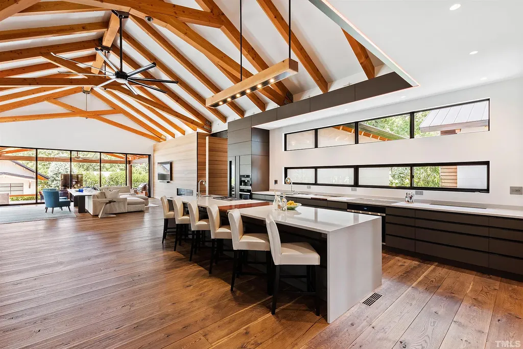 2315 Beechridge Road Home in Raleigh, North Carolina. Step into a modernist masterpiece where open living, natural light, and dramatic vaulted ceilings converge. This architectural gem is a true work of art, featuring a harmonious blend of unique natural woods, contemporary materials, and expansive windows. Discover a sanctuary of tranquility and design, nestled on an acre plus lot in Raleigh's sought-after legacy neighborhood.