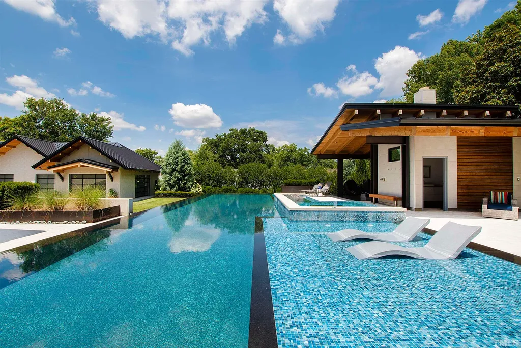 2315 Beechridge Road Home in Raleigh, North Carolina. Step into a modernist masterpiece where open living, natural light, and dramatic vaulted ceilings converge. This architectural gem is a true work of art, featuring a harmonious blend of unique natural woods, contemporary materials, and expansive windows. Discover a sanctuary of tranquility and design, nestled on an acre plus lot in Raleigh's sought-after legacy neighborhood.