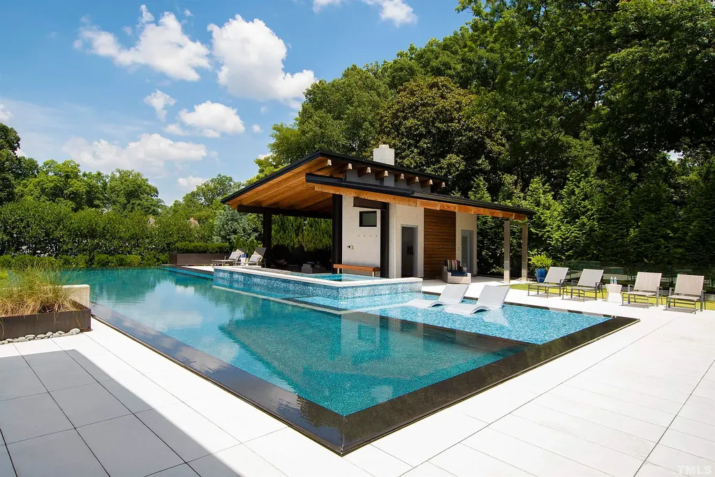 2315 Beechridge Road Home in Raleigh, North Carolina. Step into a modernist masterpiece where open living, natural light, and dramatic vaulted ceilings converge. This architectural gem is a true work of art, featuring a harmonious blend of unique natural woods, contemporary materials, and expansive windows. Discover a sanctuary of tranquility and design, nestled on an acre plus lot in Raleigh's sought-after legacy neighborhood.
