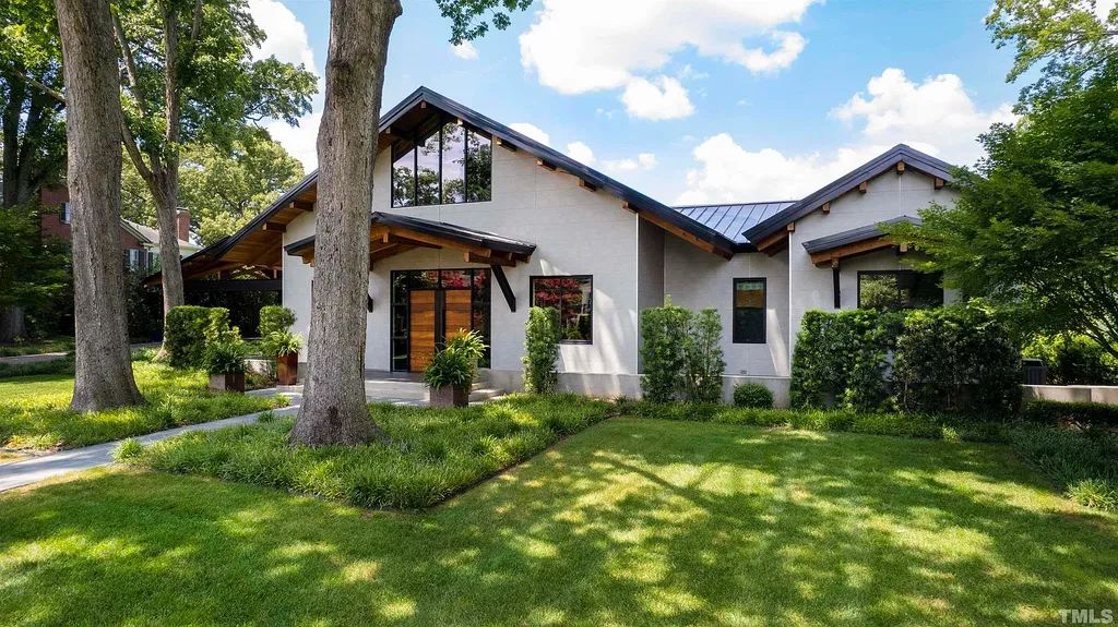 2315 Beechridge Road Home in Raleigh, North Carolina. Step into a modernist masterpiece where open living, natural light, and dramatic vaulted ceilings converge. This architectural gem is a true work of art, featuring a harmonious blend of unique natural woods, contemporary materials, and expansive windows. Discover a sanctuary of tranquility and design, nestled on an acre plus lot in Raleigh's sought-after legacy neighborhood.