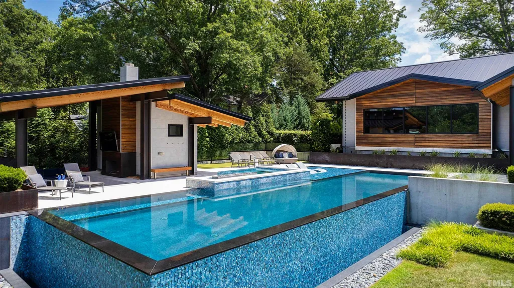 2315 Beechridge Road Home in Raleigh, North Carolina. Step into a modernist masterpiece where open living, natural light, and dramatic vaulted ceilings converge. This architectural gem is a true work of art, featuring a harmonious blend of unique natural woods, contemporary materials, and expansive windows. Discover a sanctuary of tranquility and design, nestled on an acre plus lot in Raleigh's sought-after legacy neighborhood.