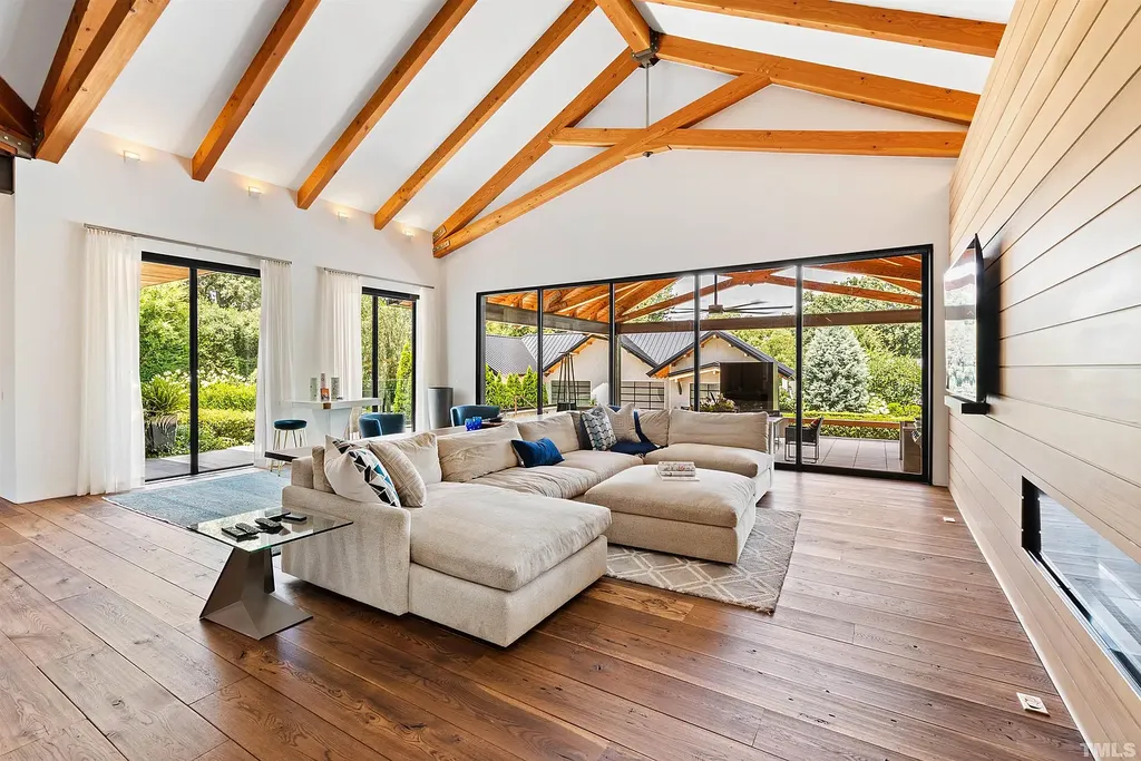 2315 Beechridge Road Home in Raleigh, North Carolina. Step into a modernist masterpiece where open living, natural light, and dramatic vaulted ceilings converge. This architectural gem is a true work of art, featuring a harmonious blend of unique natural woods, contemporary materials, and expansive windows. Discover a sanctuary of tranquility and design, nestled on an acre plus lot in Raleigh's sought-after legacy neighborhood.
