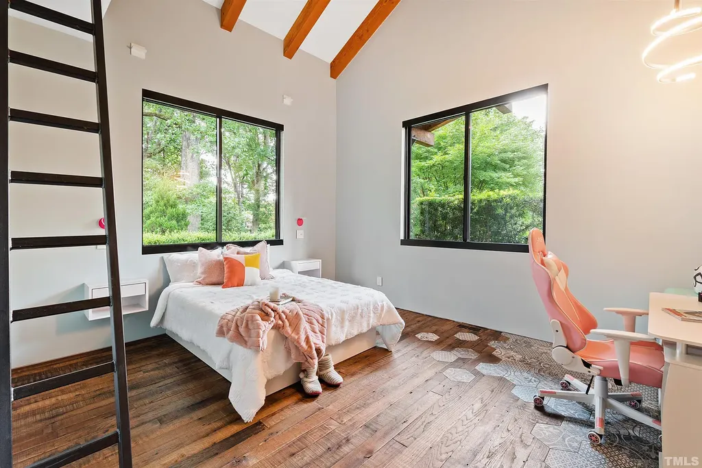 2315 Beechridge Road Home in Raleigh, North Carolina. Step into a modernist masterpiece where open living, natural light, and dramatic vaulted ceilings converge. This architectural gem is a true work of art, featuring a harmonious blend of unique natural woods, contemporary materials, and expansive windows. Discover a sanctuary of tranquility and design, nestled on an acre plus lot in Raleigh's sought-after legacy neighborhood.