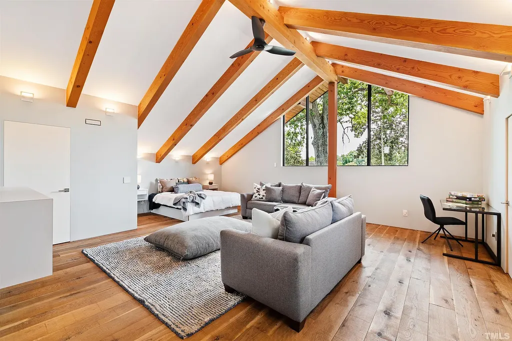 2315 Beechridge Road Home in Raleigh, North Carolina. Step into a modernist masterpiece where open living, natural light, and dramatic vaulted ceilings converge. This architectural gem is a true work of art, featuring a harmonious blend of unique natural woods, contemporary materials, and expansive windows. Discover a sanctuary of tranquility and design, nestled on an acre plus lot in Raleigh's sought-after legacy neighborhood.