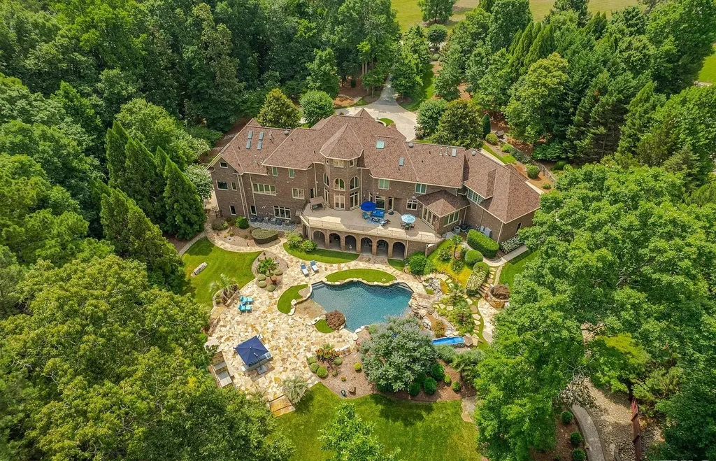 2421 Acanthus Drive Home in Wake Forest, North Carolina. Step into the world of luxury with this exceptional gated estate located in the Back Nine, featured in the Parade of Homes. Spanning 14,438 sqft, this masterfully crafted home boasts 6 bedrooms, 9 bathrooms, and lavish finishes throughout. Enjoy the grand foyer, two kitchens, theater room, wine cellar, and exercise room.