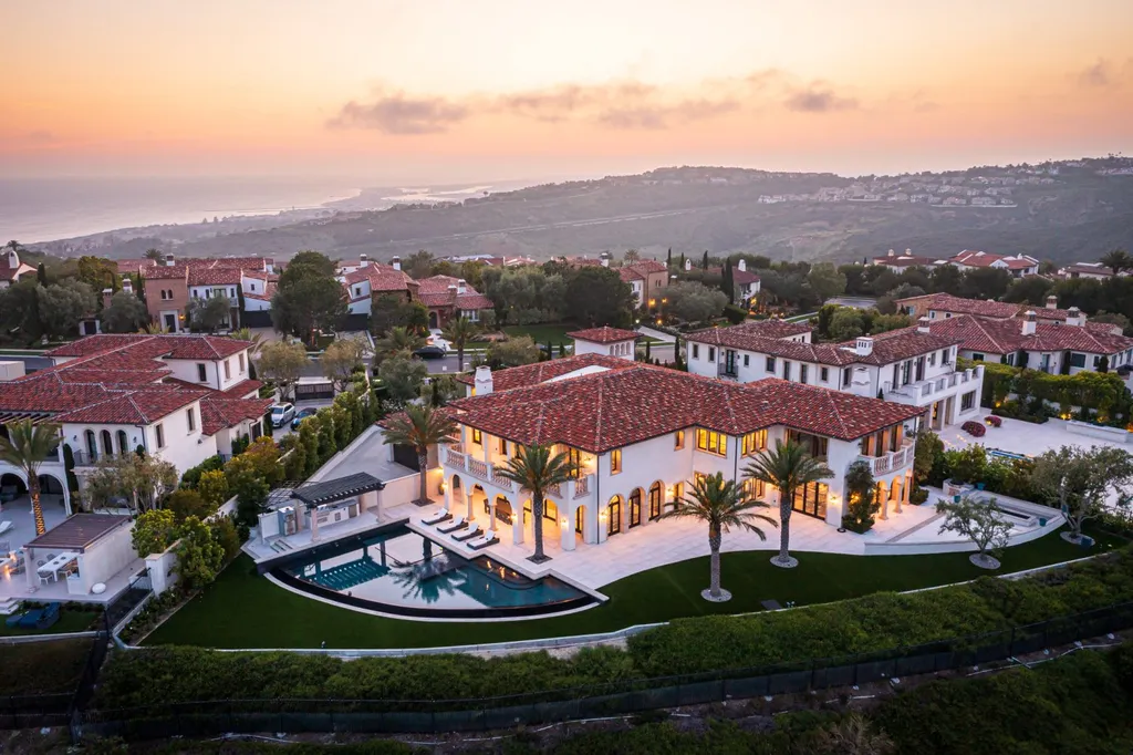 28 Tide Watch Home in Newport Beach, California. Discover the epitome of modern luxury in the prestigious Crystal Cove community. This sophisticated custom-built home boasts sweeping ocean and mountain views, six bedrooms, eight baths, and state-of-the-art technology. Impeccable craftsmanship and high-end finishes are complemented by spacious entertainment areas, indoor/outdoor living, and a stunning backyard with a pool, spa, and alfresco dining options.