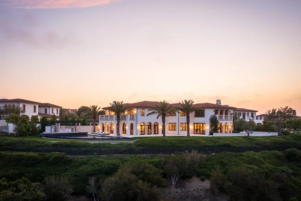 28 Tide Watch Home in Newport Beach, California. Discover the epitome of modern luxury in the prestigious Crystal Cove community. This sophisticated custom-built home boasts sweeping ocean and mountain views, six bedrooms, eight baths, and state-of-the-art technology. Impeccable craftsmanship and high-end finishes are complemented by spacious entertainment areas, indoor/outdoor living, and a stunning backyard with a pool, spa, and alfresco dining options.