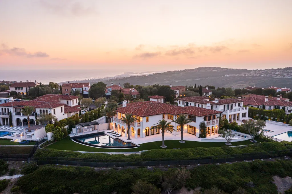 28 Tide Watch Home in Newport Beach, California. Discover the epitome of modern luxury in the prestigious Crystal Cove community. This sophisticated custom-built home boasts sweeping ocean and mountain views, six bedrooms, eight baths, and state-of-the-art technology. Impeccable craftsmanship and high-end finishes are complemented by spacious entertainment areas, indoor/outdoor living, and a stunning backyard with a pool, spa, and alfresco dining options.