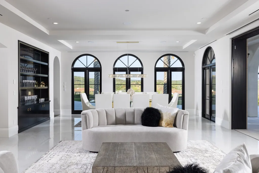 28 Tide Watch Home in Newport Beach, California. Discover the epitome of modern luxury in the prestigious Crystal Cove community. This sophisticated custom-built home boasts sweeping ocean and mountain views, six bedrooms, eight baths, and state-of-the-art technology. Impeccable craftsmanship and high-end finishes are complemented by spacious entertainment areas, indoor/outdoor living, and a stunning backyard with a pool, spa, and alfresco dining options.