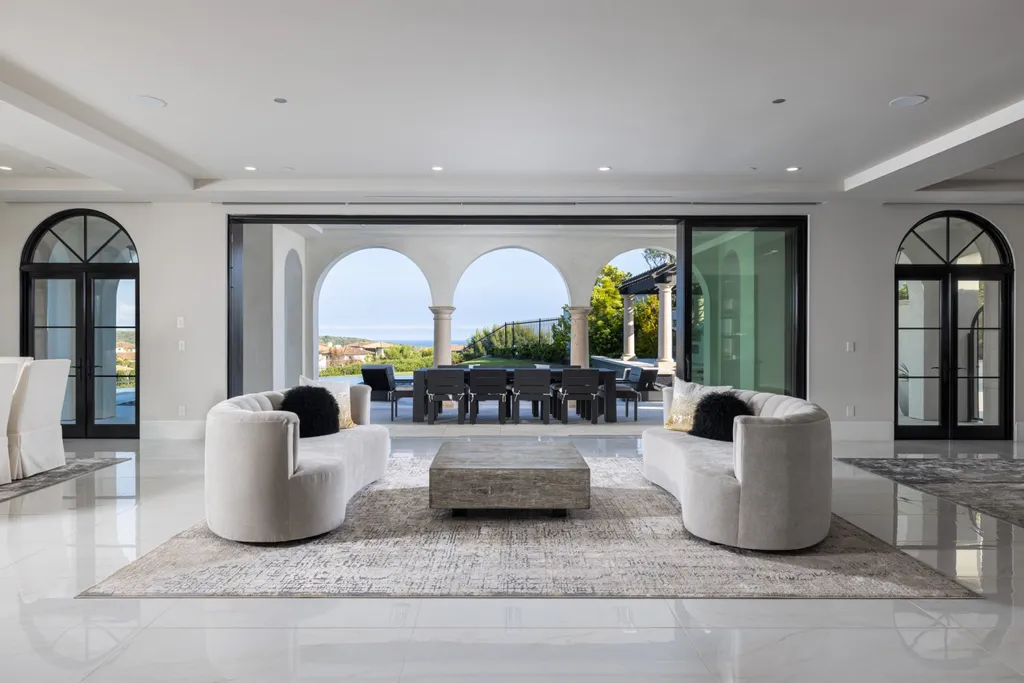 28 Tide Watch Home in Newport Beach, California. Discover the epitome of modern luxury in the prestigious Crystal Cove community. This sophisticated custom-built home boasts sweeping ocean and mountain views, six bedrooms, eight baths, and state-of-the-art technology. Impeccable craftsmanship and high-end finishes are complemented by spacious entertainment areas, indoor/outdoor living, and a stunning backyard with a pool, spa, and alfresco dining options.