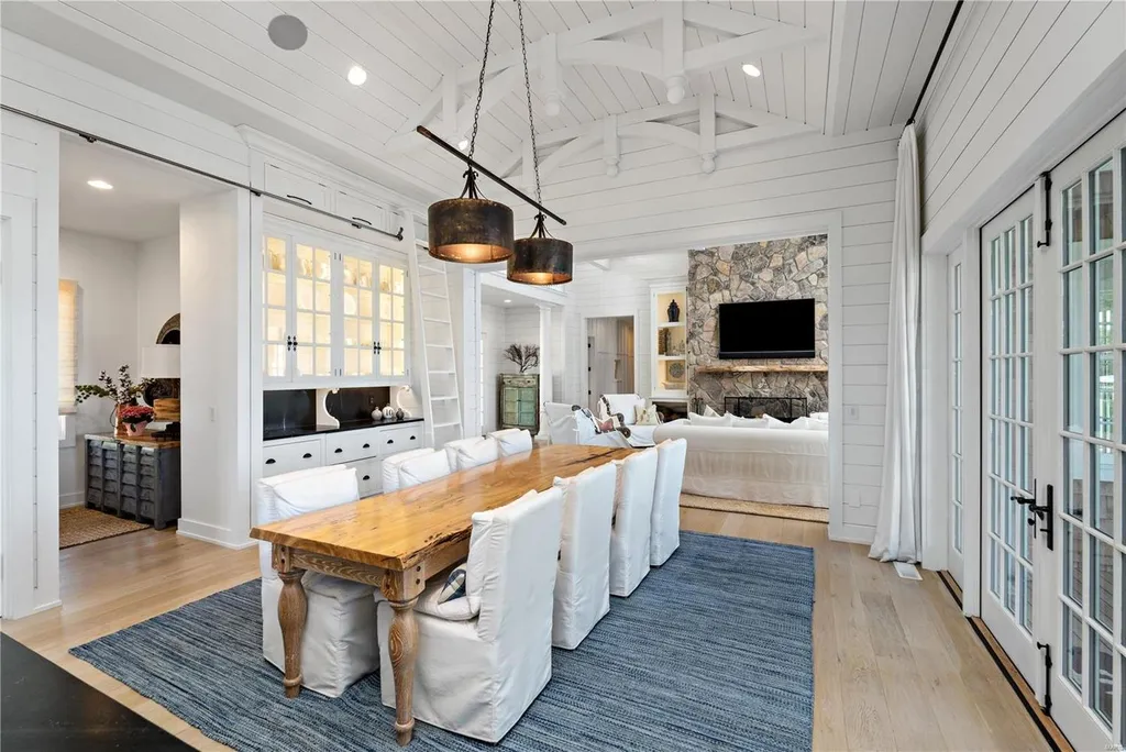 282 Timber Ridge Lane Home in Lake Ozark, Missouri. "Nantucket Point" is the ultimate Crown Jewel of Lake of The Ozarks, offering 1.24 acres of unparalleled beauty with 500' of shoreline, deep water, and breathtaking views. This Nantucket-inspired 6,800 sqft estate exudes laid-back luxury and coastal design, featuring 6 ensuite bedrooms, 2 gourmet kitchens, a gym, game room, and more. 