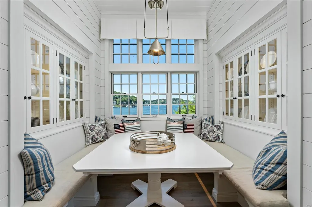 282 Timber Ridge Lane Home in Lake Ozark, Missouri. "Nantucket Point" is the ultimate Crown Jewel of Lake of The Ozarks, offering 1.24 acres of unparalleled beauty with 500' of shoreline, deep water, and breathtaking views. This Nantucket-inspired 6,800 sqft estate exudes laid-back luxury and coastal design, featuring 6 ensuite bedrooms, 2 gourmet kitchens, a gym, game room, and more. 