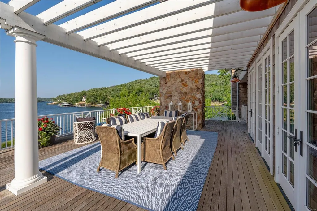 282 Timber Ridge Lane Home in Lake Ozark, Missouri. "Nantucket Point" is the ultimate Crown Jewel of Lake of The Ozarks, offering 1.24 acres of unparalleled beauty with 500' of shoreline, deep water, and breathtaking views. This Nantucket-inspired 6,800 sqft estate exudes laid-back luxury and coastal design, featuring 6 ensuite bedrooms, 2 gourmet kitchens, a gym, game room, and more. 
