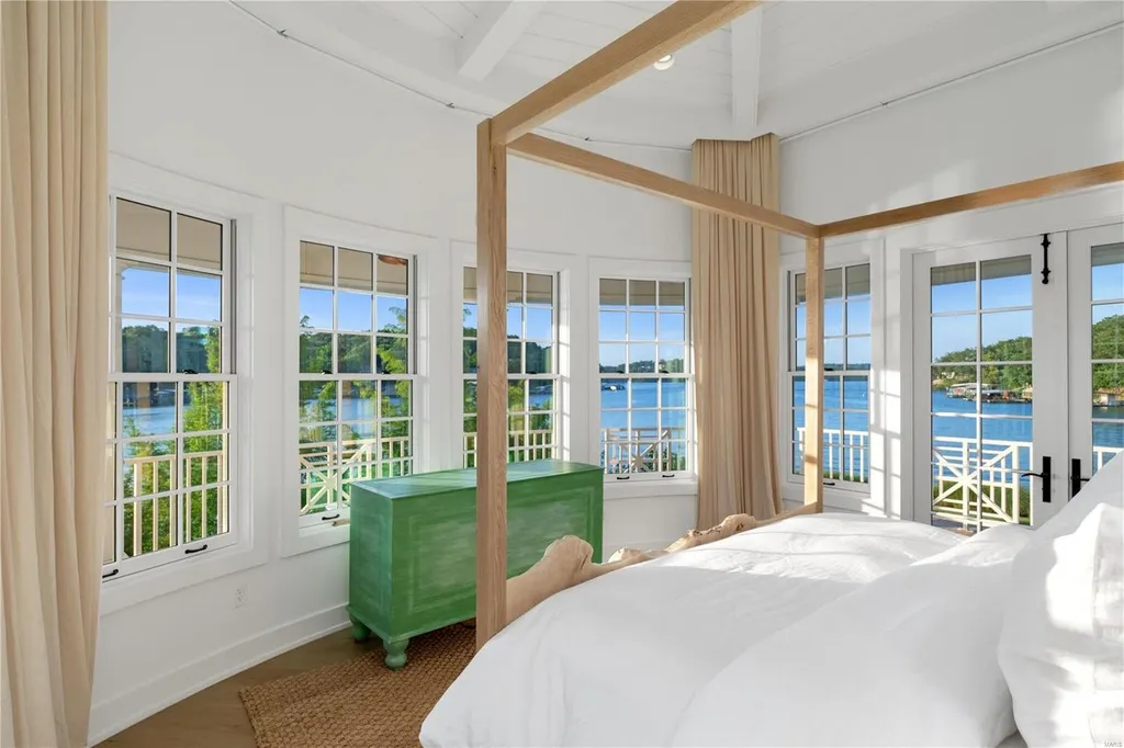 282 Timber Ridge Lane Home in Lake Ozark, Missouri. "Nantucket Point" is the ultimate Crown Jewel of Lake of The Ozarks, offering 1.24 acres of unparalleled beauty with 500' of shoreline, deep water, and breathtaking views. This Nantucket-inspired 6,800 sqft estate exudes laid-back luxury and coastal design, featuring 6 ensuite bedrooms, 2 gourmet kitchens, a gym, game room, and more. 