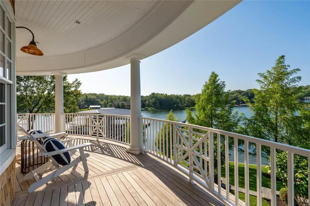 282 Timber Ridge Lane Home in Lake Ozark, Missouri. "Nantucket Point" is the ultimate Crown Jewel of Lake of The Ozarks, offering 1.24 acres of unparalleled beauty with 500' of shoreline, deep water, and breathtaking views. This Nantucket-inspired 6,800 sqft estate exudes laid-back luxury and coastal design, featuring 6 ensuite bedrooms, 2 gourmet kitchens, a gym, game room, and more. 