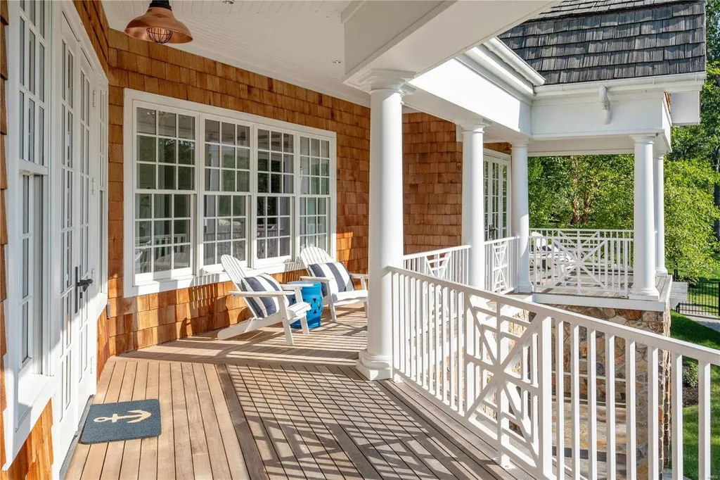 282 Timber Ridge Lane Home in Lake Ozark, Missouri. "Nantucket Point" is the ultimate Crown Jewel of Lake of The Ozarks, offering 1.24 acres of unparalleled beauty with 500' of shoreline, deep water, and breathtaking views. This Nantucket-inspired 6,800 sqft estate exudes laid-back luxury and coastal design, featuring 6 ensuite bedrooms, 2 gourmet kitchens, a gym, game room, and more. 