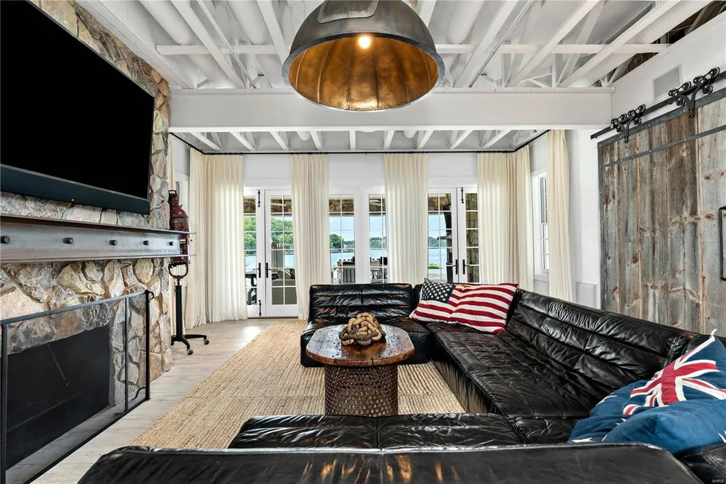 282 Timber Ridge Lane Home in Lake Ozark, Missouri. "Nantucket Point" is the ultimate Crown Jewel of Lake of The Ozarks, offering 1.24 acres of unparalleled beauty with 500' of shoreline, deep water, and breathtaking views. This Nantucket-inspired 6,800 sqft estate exudes laid-back luxury and coastal design, featuring 6 ensuite bedrooms, 2 gourmet kitchens, a gym, game room, and more. 
