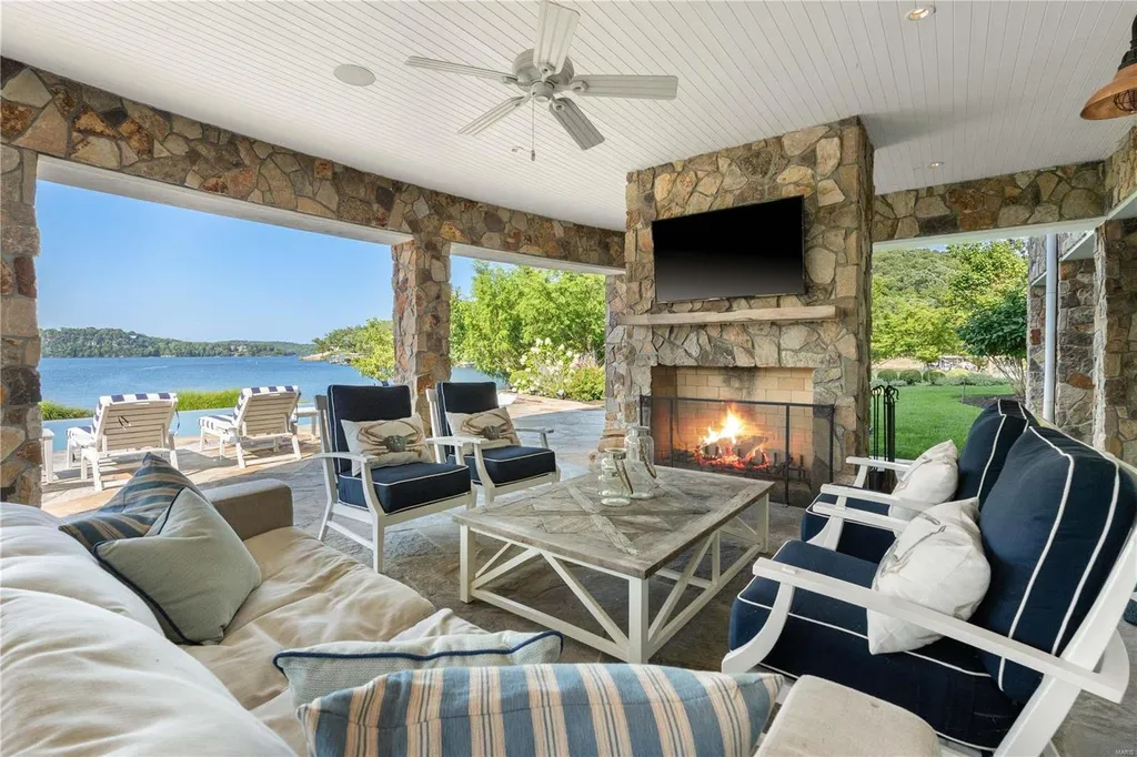 282 Timber Ridge Lane Home in Lake Ozark, Missouri. "Nantucket Point" is the ultimate Crown Jewel of Lake of The Ozarks, offering 1.24 acres of unparalleled beauty with 500' of shoreline, deep water, and breathtaking views. This Nantucket-inspired 6,800 sqft estate exudes laid-back luxury and coastal design, featuring 6 ensuite bedrooms, 2 gourmet kitchens, a gym, game room, and more. 