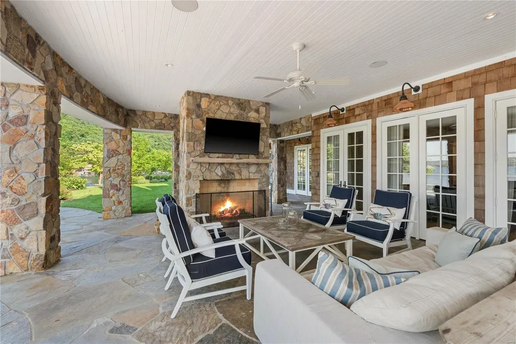 282 Timber Ridge Lane Home in Lake Ozark, Missouri. "Nantucket Point" is the ultimate Crown Jewel of Lake of The Ozarks, offering 1.24 acres of unparalleled beauty with 500' of shoreline, deep water, and breathtaking views. This Nantucket-inspired 6,800 sqft estate exudes laid-back luxury and coastal design, featuring 6 ensuite bedrooms, 2 gourmet kitchens, a gym, game room, and more. 