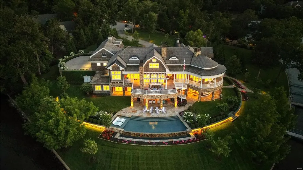 282 Timber Ridge Lane Home in Lake Ozark, Missouri. "Nantucket Point" is the ultimate Crown Jewel of Lake of The Ozarks, offering 1.24 acres of unparalleled beauty with 500' of shoreline, deep water, and breathtaking views. This Nantucket-inspired 6,800 sqft estate exudes laid-back luxury and coastal design, featuring 6 ensuite bedrooms, 2 gourmet kitchens, a gym, game room, and more. 