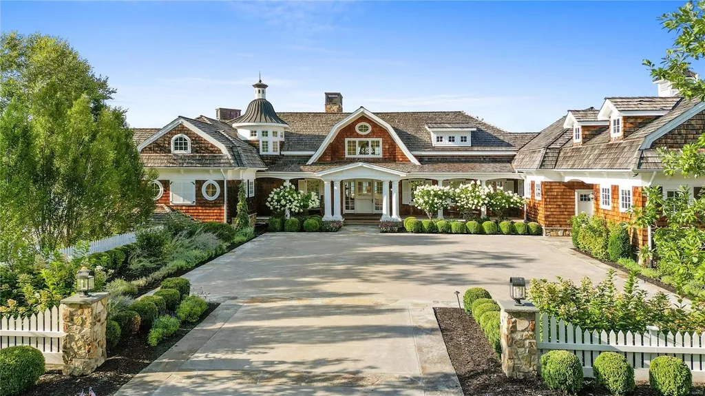 282 Timber Ridge Lane Home in Lake Ozark, Missouri. "Nantucket Point" is the ultimate Crown Jewel of Lake of The Ozarks, offering 1.24 acres of unparalleled beauty with 500' of shoreline, deep water, and breathtaking views. This Nantucket-inspired 6,800 sqft estate exudes laid-back luxury and coastal design, featuring 6 ensuite bedrooms, 2 gourmet kitchens, a gym, game room, and more. 