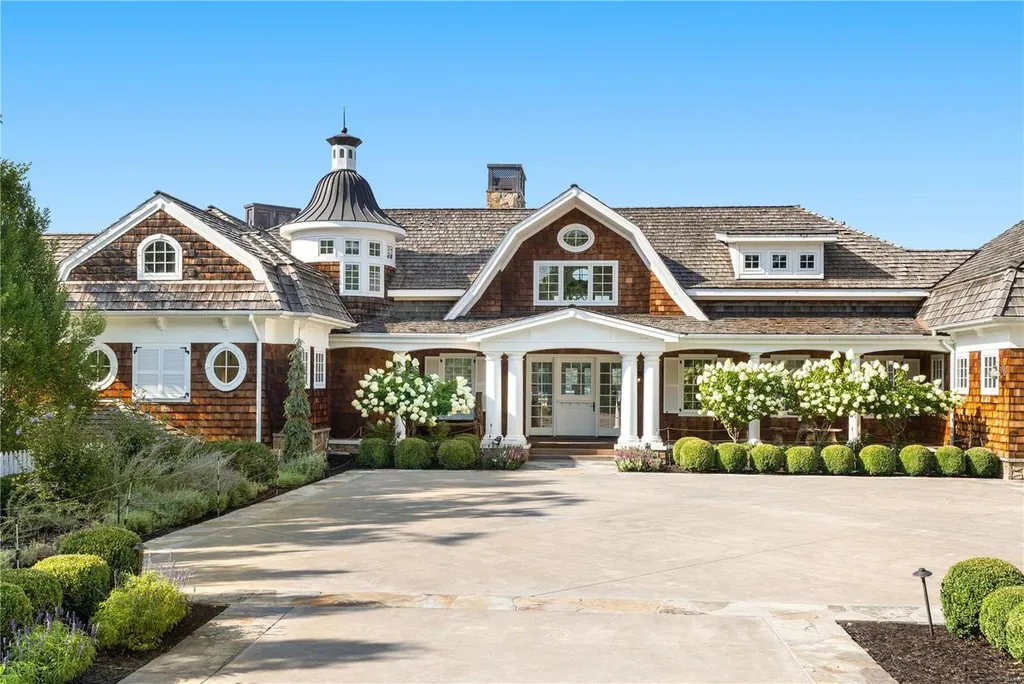 282 Timber Ridge Lane Home in Lake Ozark, Missouri. "Nantucket Point" is the ultimate Crown Jewel of Lake of The Ozarks, offering 1.24 acres of unparalleled beauty with 500' of shoreline, deep water, and breathtaking views. This Nantucket-inspired 6,800 sqft estate exudes laid-back luxury and coastal design, featuring 6 ensuite bedrooms, 2 gourmet kitchens, a gym, game room, and more. 